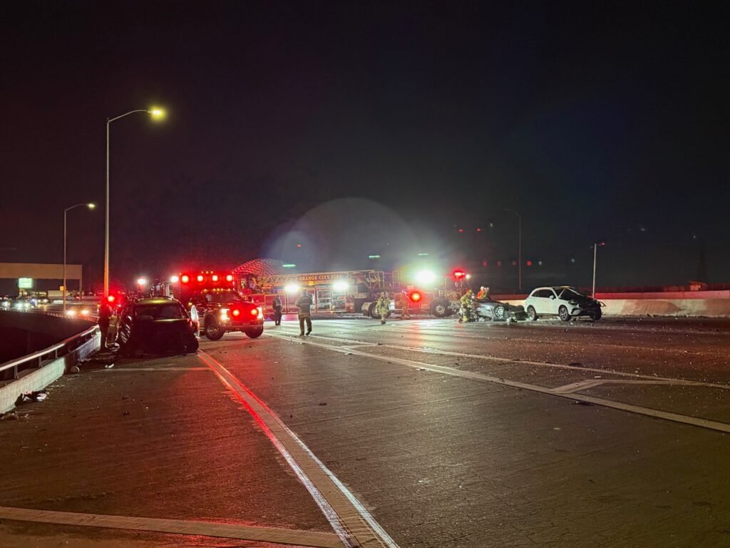 Emergency vehicles blocking southbound 57 Freeway lanes at night