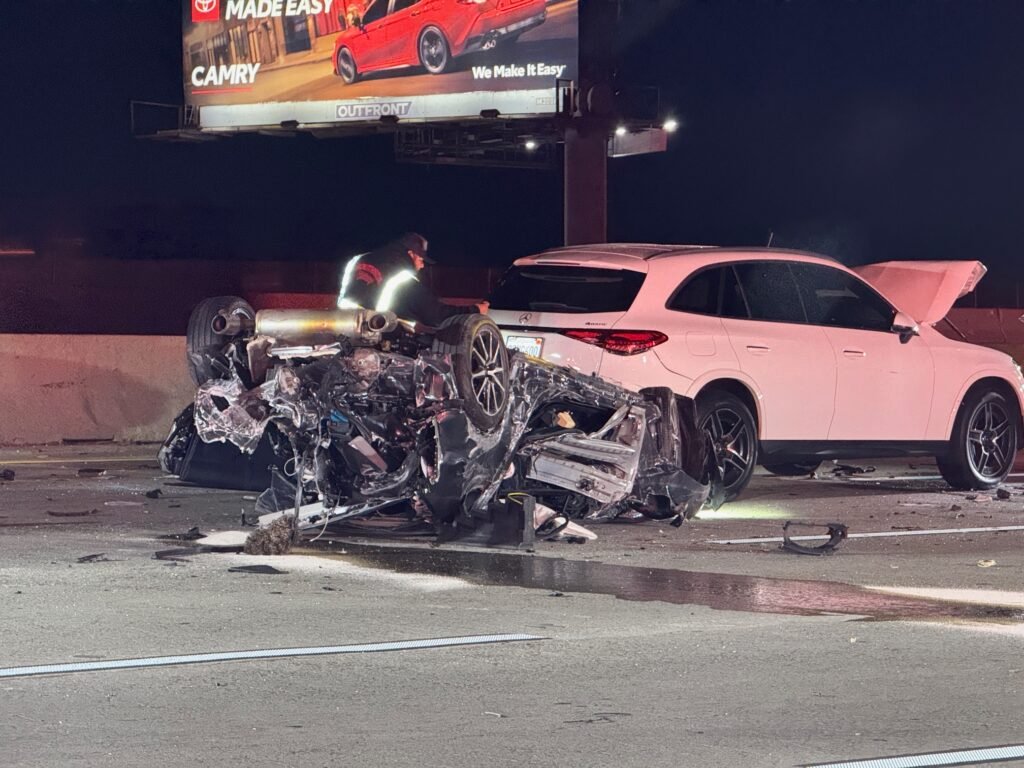 Wrecked vehicle and debris near stopped traffic on southbound 57