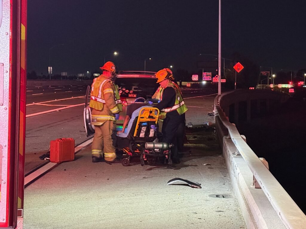 Firefighters preparing stretcher at freeway crash scene