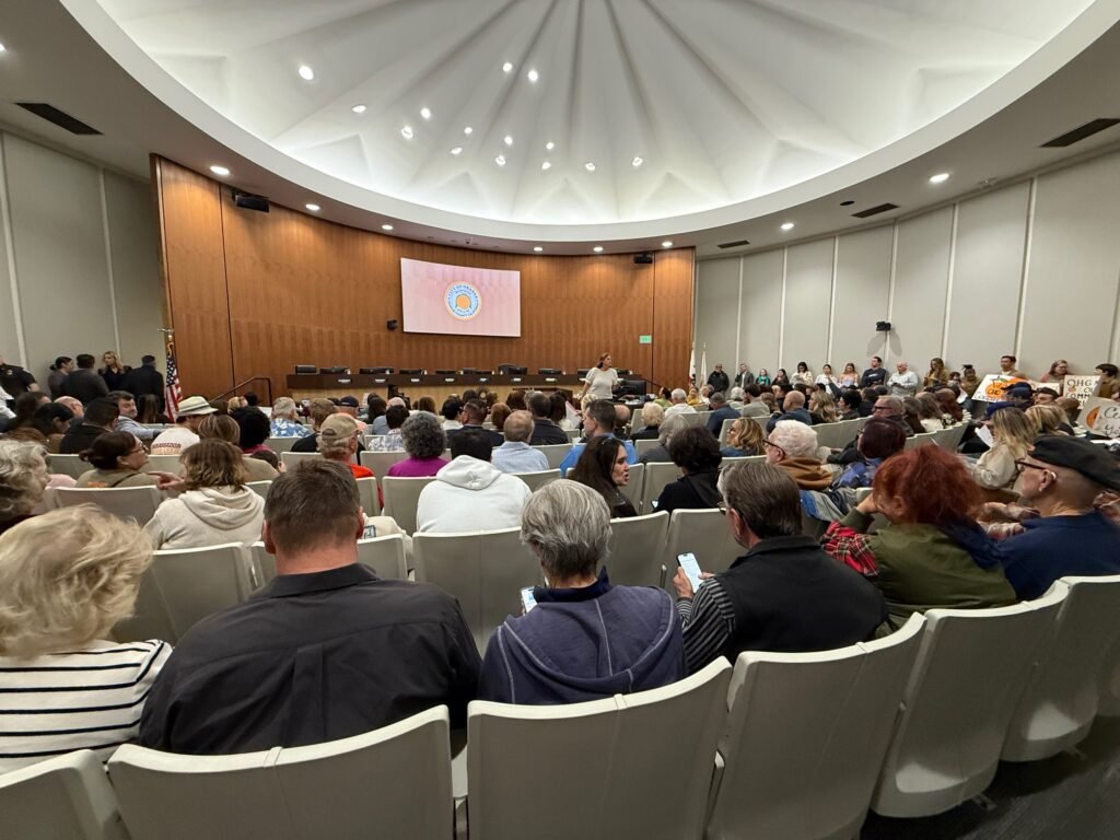 Full audience inside the Orange City Council chamber as the public gathers during labor dispute discussions
