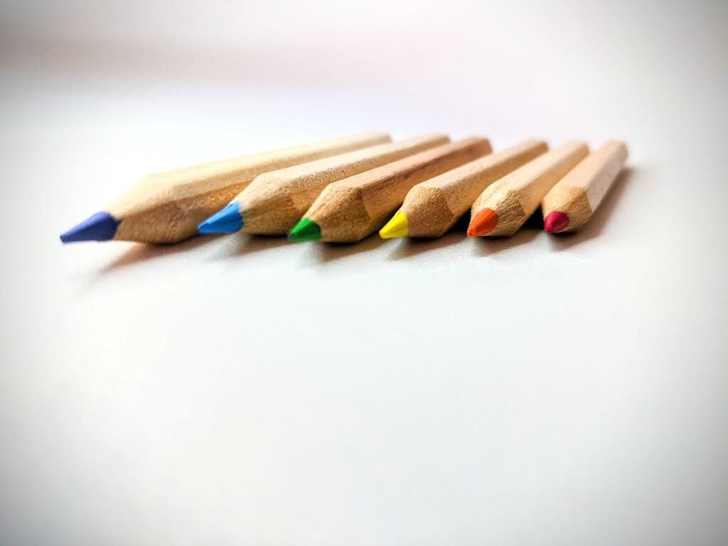 Six sharpened colored pencils arranged side by side.